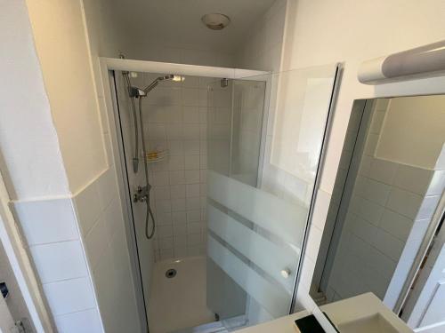 a bathroom with a shower with a glass door at Résidence du Loir - Le Petit Loft in Vendôme