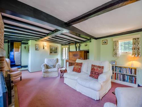 a living room with two white couches and chairs at Glebe Cottage in Powick