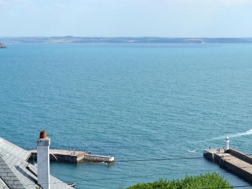 a view of a large body of water with a lighthouse at Morvoren - Ukc3539 in Mevagissey