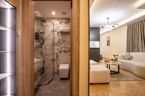 a bathroom with a toilet and a shower in a room at P Quattro Relax Hotel in Wadi Musa
