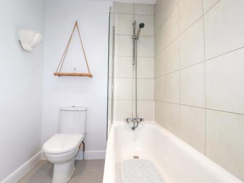 a bathroom with a toilet and a bath tub at Trelowen in Wadebridge