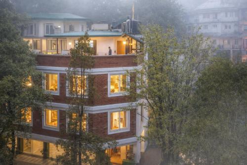 a building with lights on in a city at night at Hotel LA Eden in Mussoorie