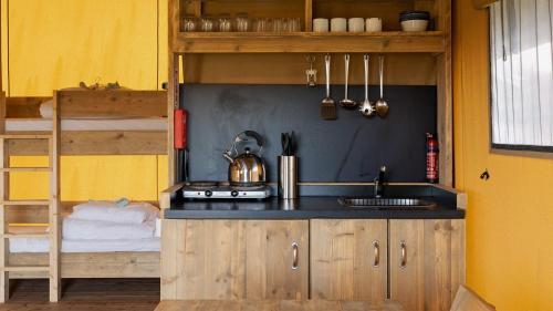 a kitchen with a sink and a bunk bed at The Camp at The Wave in Bristol