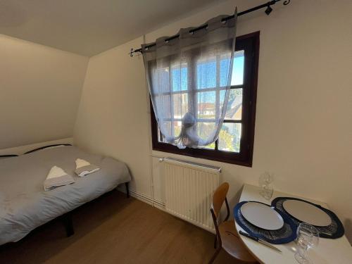 a small bedroom with a bed and a window at L Atelier du Centre in Vendôme