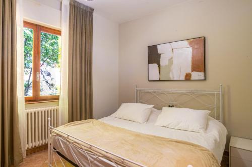 a bedroom with a bed with a picture on the wall at Villa Panoramica in Perledo