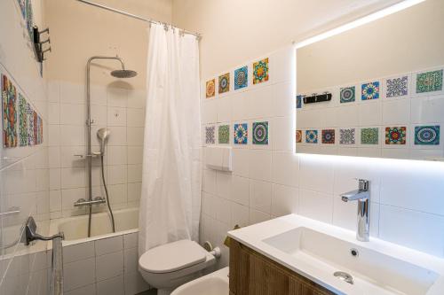 a bathroom with a sink and a toilet and a shower at Villa Panoramica in Perledo