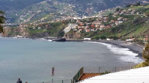 a view of a beach with houses on a hill at Apartment Bonimar in Funchal