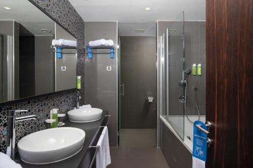 a bathroom with two sinks and a shower at Brijuni Hotel Istra in Brijuni