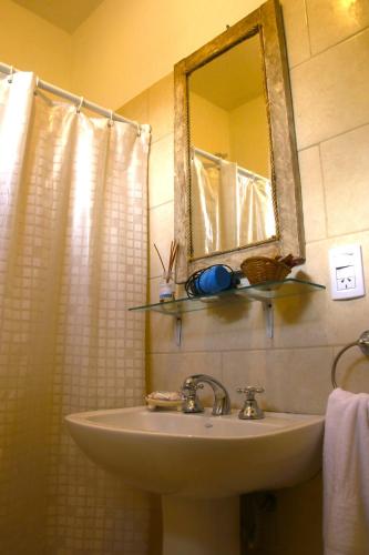 a bathroom with a sink and a mirror at Lo de Ine in La Cumbre