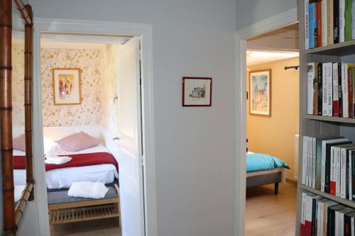 a bedroom with a bed and a book shelf with books at La Solitude in Bois-de-Cené