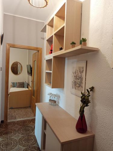 a kitchen with a counter and a room with a bed at La Yucca in Dolceacqua