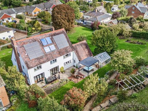 an aerial view of a house with solar panels on it at Blackthorn House in Blandford Forum