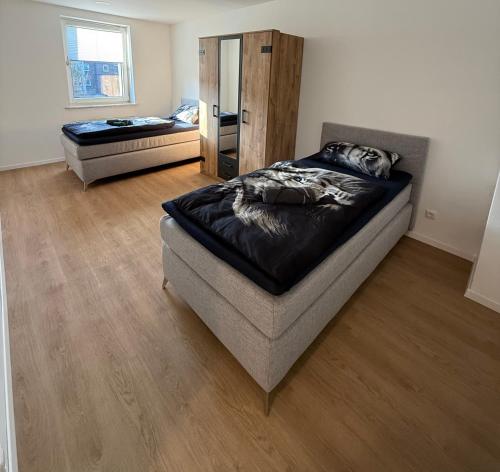 a bedroom with a bed and a futon in it at Schalke Unterkunft in Gelsenkirchen