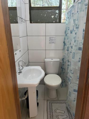 a small bathroom with a toilet and a sink at Morada da Lua in Foz do Iguaçu