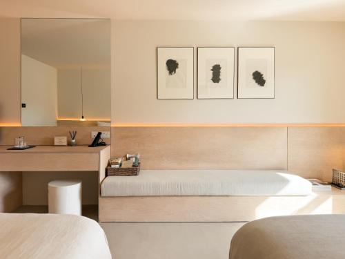 a bedroom with two beds and a desk and a bed sidx sidx sidx at Fiddle + Bow Hotel in Doolin