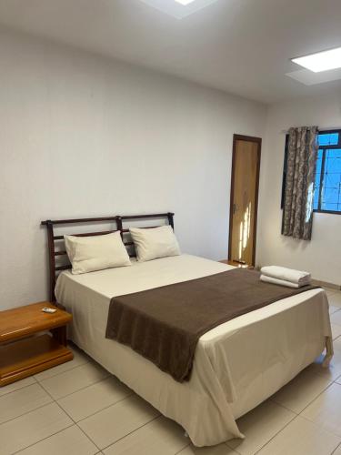 a bedroom with a large bed in a room at Morada da Lua in Foz do Iguaçu