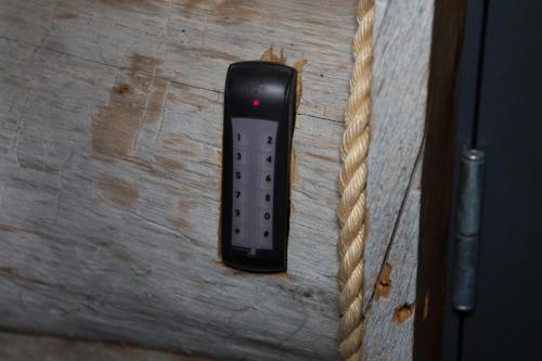 a remote control on a wooden table with a rope at Aamukka A&B in Levi