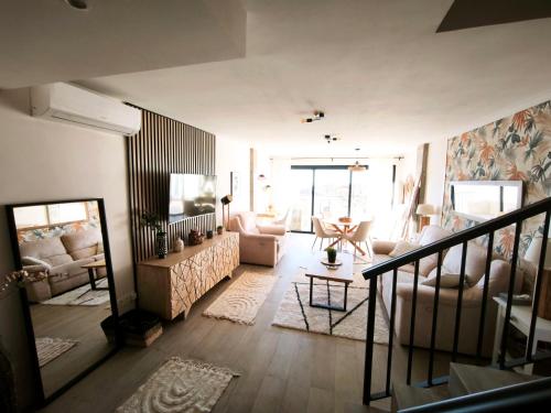 a living room with a couch and a table at Duplex Apartman with sunny terrace in Mijas Pueblo in Mijas