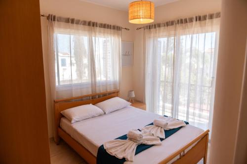 a bedroom with a bed and a large window at Dream Olea Villa - Ayia Napa in Ayia Napa