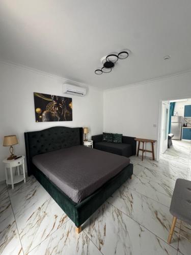 a bedroom with a bed and a couch at Sea View Chic Apartment in Karianí