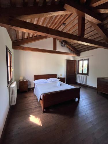 a bedroom with a large bed in a room with wooden ceilings at Villa Riviera in Mira