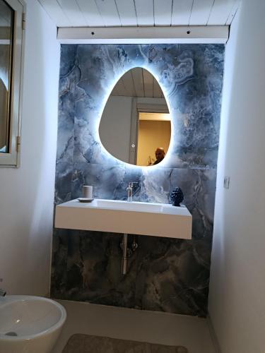 a bathroom with a sink and a mirror at Casa vacanze So Suite 24 in Reggio di Calabria