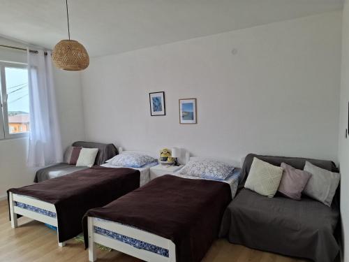 a living room with two beds and a couch at Apartmans White perl in Sutomore