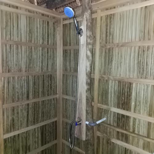 a shower in a bathroom with a shower curtain at Batanta Explorers in Pulau Saonek-kecil