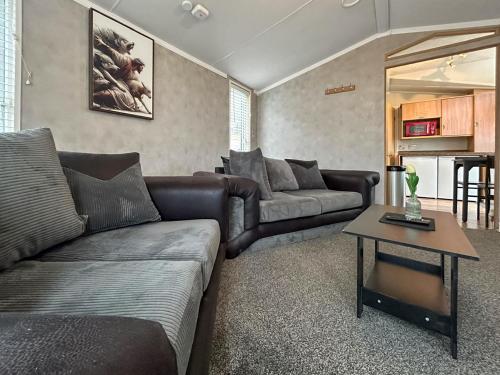 a living room with a couch and a table at The Meadow - Uk51411 in Brechin