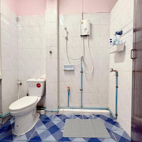 a bathroom with a toilet and a shower at REHome in Bangkok
