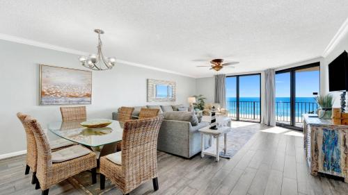 a dining room and living room with a table and chairs at Phoenix X 514 condo in Orange Beach