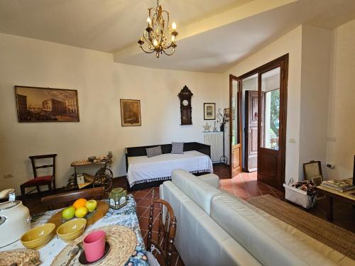 a living room with a couch and a bed at Villa Carla - vicino alla Riviera del Conero e ai Colli dell' Infinito in Ancona