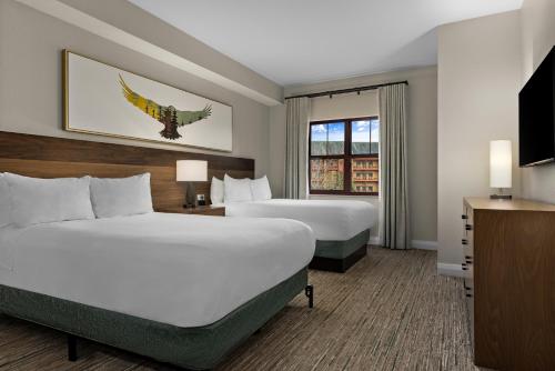 a hotel room with two beds and a window at Club Wyndham Great Smokies Lodge in Sevierville