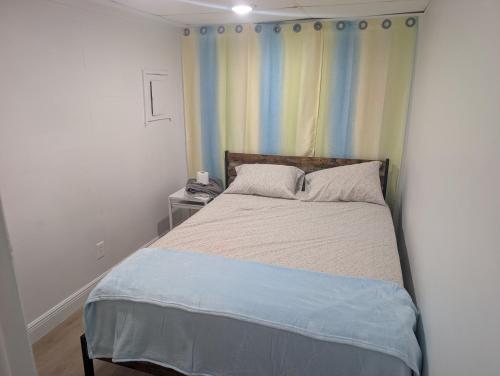 a bedroom with a bed with a blue blanket at Bungalow Bleu in St. Petersburg