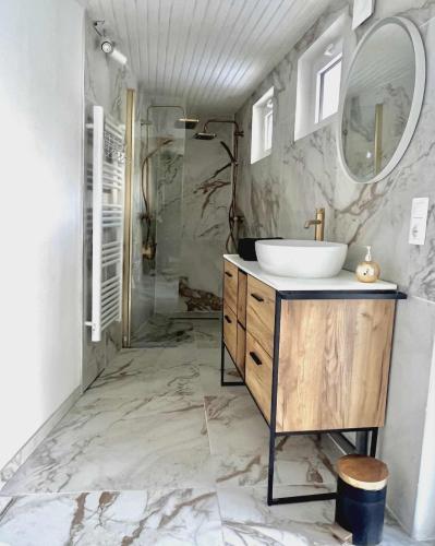a bathroom with a sink and a mirror at Romantic love room house in Aix