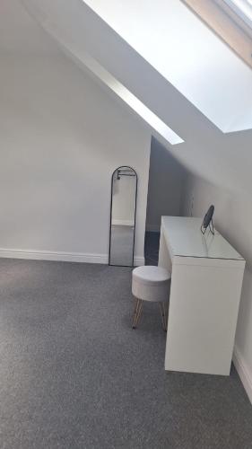 a room with a white desk and a chair at Modern spacious private detached house in Beeston