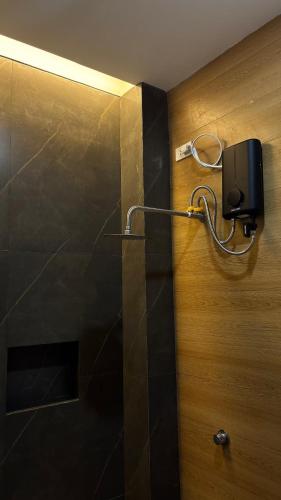 a bathroom with a shower with a soap dispenser on the wall at R&G Residences in Legazpi