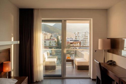 a hotel room with a view of a living room at Avala Resort & Villas in Budva