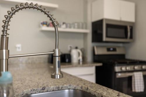a kitchen with a sink in a kitchen with a counter at Boston Landing Stays in Boston