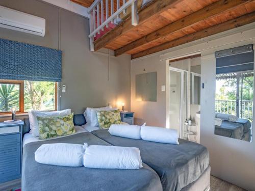 a bedroom with two beds with pillows at A Stone's Throw in Grahamstown