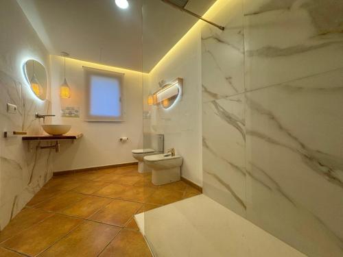 a bathroom with a toilet and a sink and a shower at Serena Villa in Ibiza Town