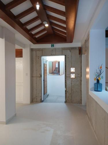 an empty room with a vaulted ceiling and a hallway at Hiddenhill Bulkuksa Hotel in Gyeongju