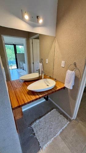a bathroom with a counter with two surfboards on it at Cabañas Indómita in El Bolsón