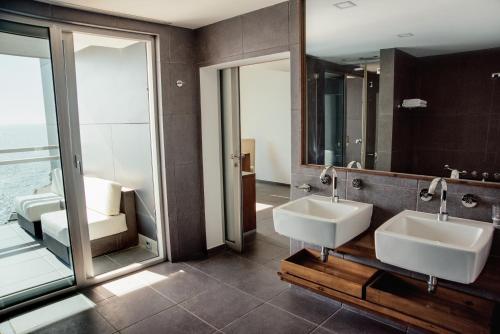 a bathroom with two sinks and a mirror at Avala Resort & Villas in Budva