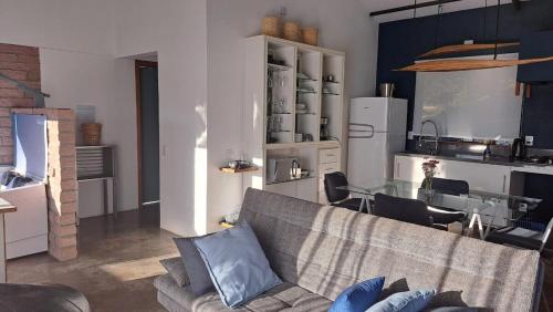 a living room with a couch and a table at Refúgio na Serra com Pôr do Sol in Feliz