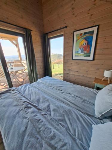 a bedroom with a bed and a large window at Sümeg Horizon in Sümeg