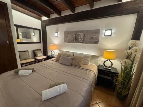 a bedroom with a large bed with two lamps at Serena Villa in Ibiza Town