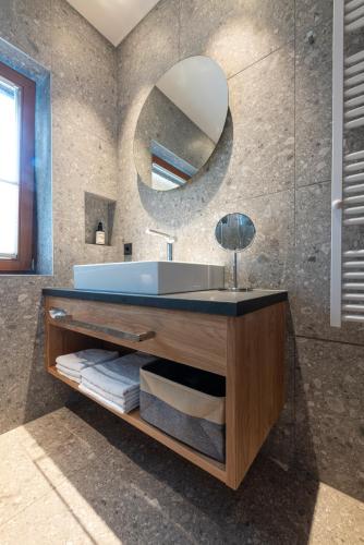 a bathroom with a sink and a mirror at Hotel Untersberg in Sankt Leonhard