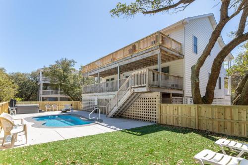 a house with a patio and a swimming pool at Gone With The Wind - Duck, Gull's Flight, 325 Yds to Beach, Pool, Hot Tub, Pets OK, Quiet St, Flex Stays in Duck