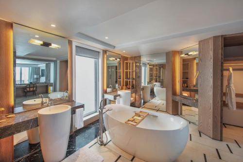a bathroom with a large bath tub and a sink at Shangri-La Le Touessrok, Mauritius in Trou d'Eau Douce